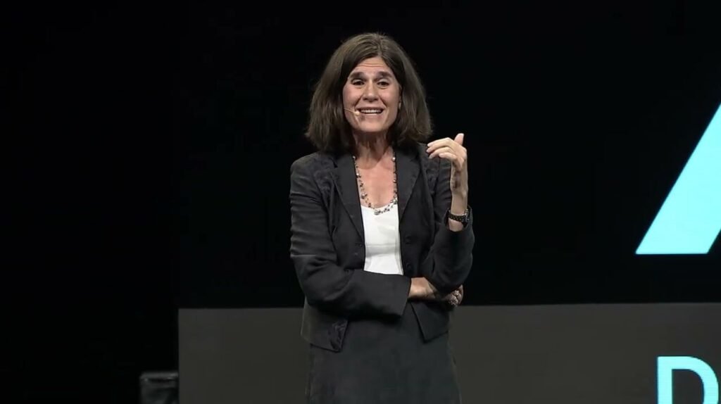Woman in a leather jacket speaking at a crypto panel discussion