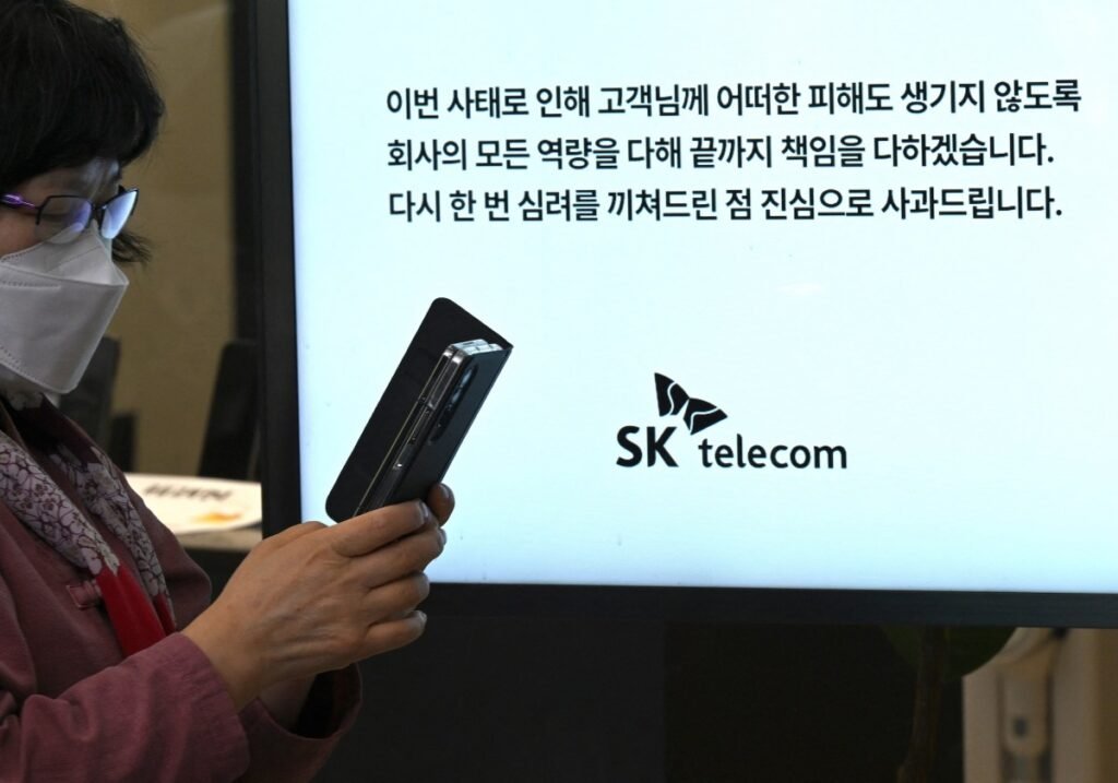 A breach every month raises doubts about South Korea’s digital defenses A woman uses her mobile phone while waiting to replace her USIM ship in front of an SK Telecom branch in Seoul on April 28, 2025.