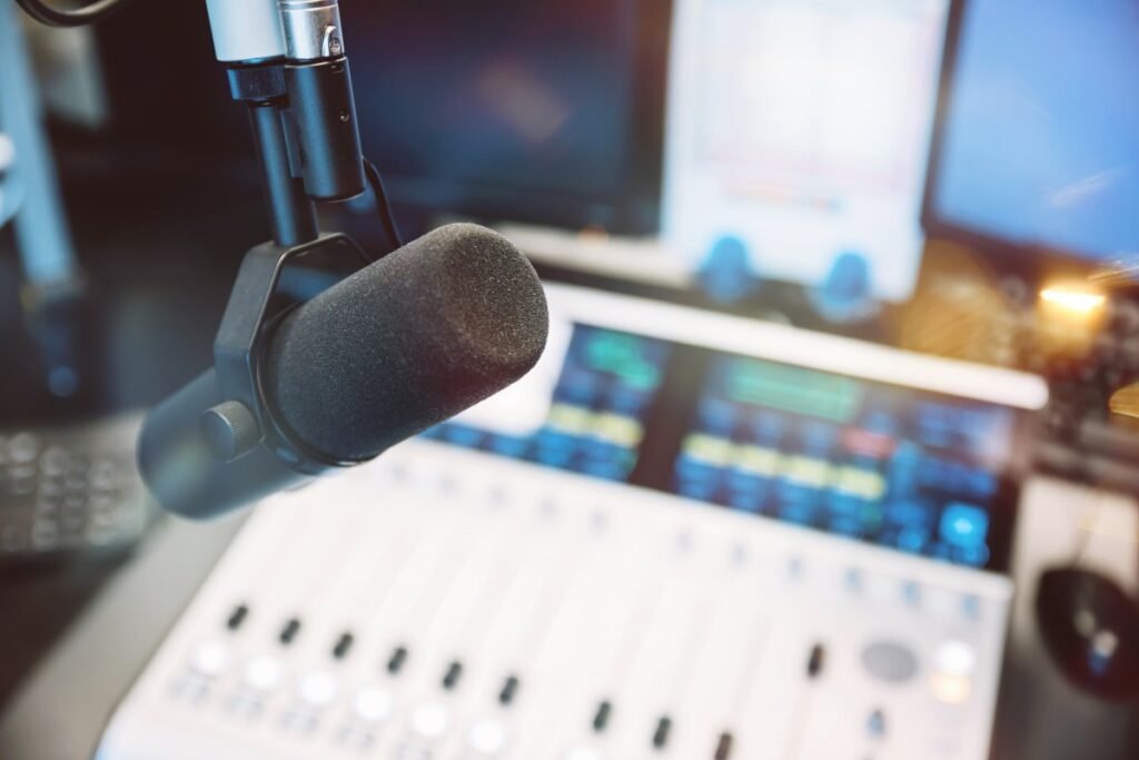 Warner Music settles copyright lawsuit with Udio, signs deal for AI music platform Close up of microphone in radio broadcast studio