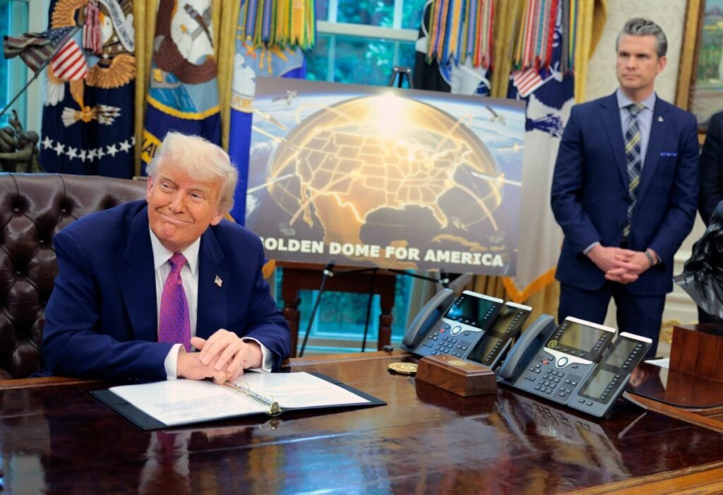 Tech workers urge DOD, Congress to withdraw Anthropic label as a supply chain risk Golden Dome missile program placard with Trump sitting at desk